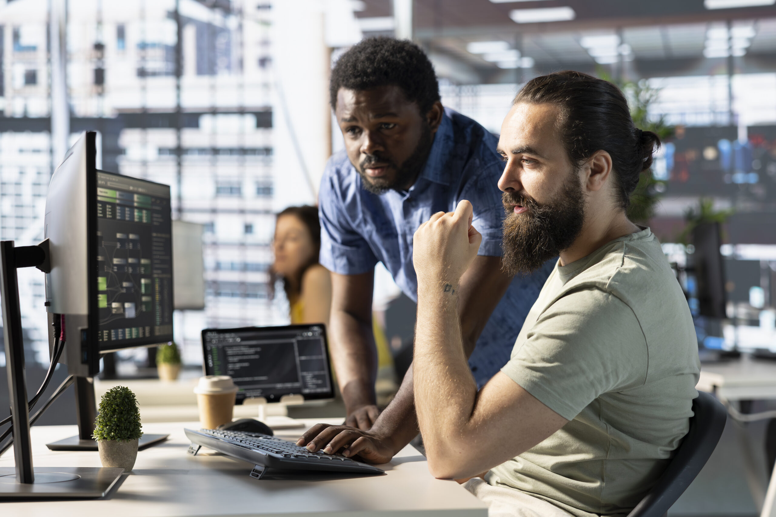 Programmer and colleague in office, training machine learning algorithms