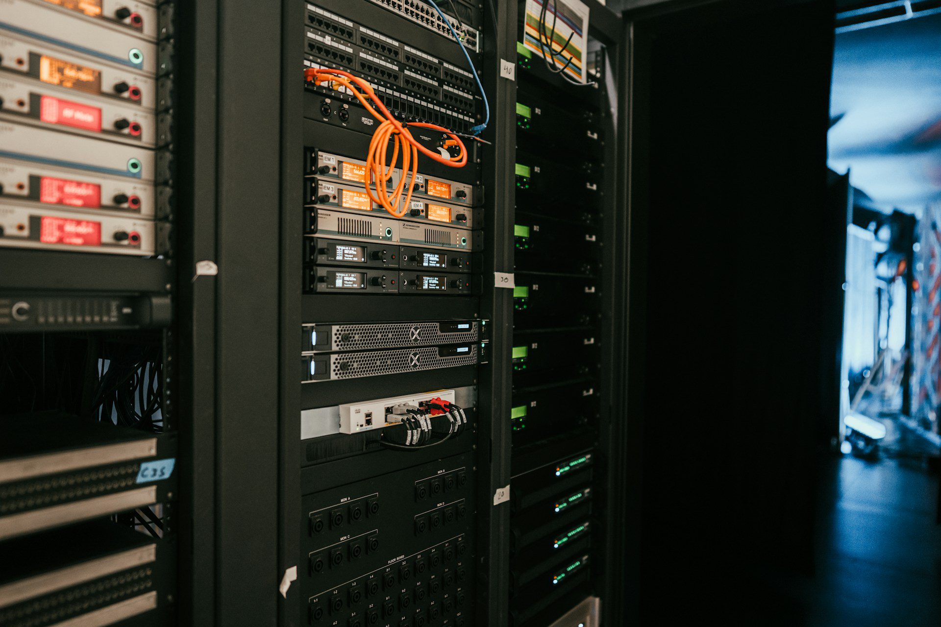 php2shell-php-vulnerability-header-unsplash-2JJ3wBHu4_0 Rack of web servers with patch cables in a server room, illustrating the PHP2Shell vulnerability